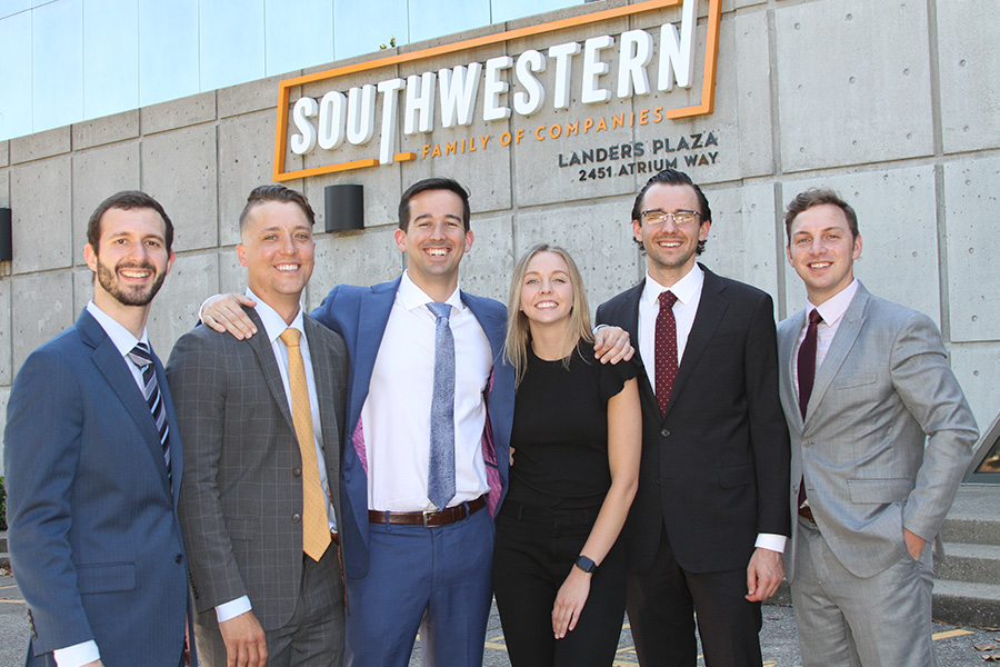 About Our Agency - Team Portrait of Southwestern Insurance Group Standing in Front of Southwest Family Companies Building on a Sunny Day